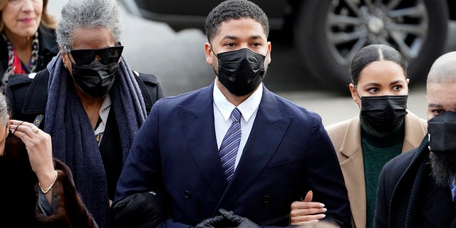 Actor Jussie Smollett walks with family members as they arrive on Monday, Nov. 29, 2021, at the Leighton Criminal Courthouse for jury selection at his trial in Chicago.