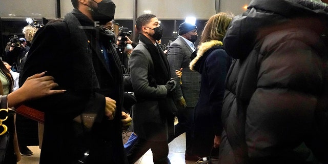 Actor Jussie Smollett, center, returns to the Leighton Criminal Courthouse, Thursday, Dec. 9, 2021, in Chicago. Smollett was convicted Thursday on five of six charges he staged an anti-gay, racist attack on himself nearly three years ago and then lied to Chicago police about it. 