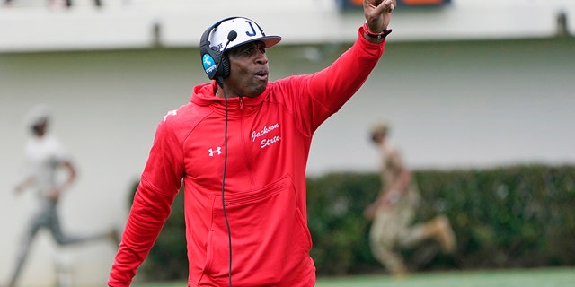 Jackson State football coach Deion Sanders calls out to his players during the first half of a game against Edward Waters in Jackson, Miss., Feb. 21, 2021. The game marked Sanders's collegiate head coaching debut. (AP Photo/Rogelio V. Solis)