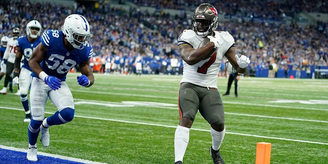 Tampa Bay Buccaneers' Leonard Fournette (7) goes in for a touchdown against Indianapolis Colts' Bobby Okereke (58) during the first half of an NFL football game, Sunday, Nov. 28, 2021, in Indianapolis.