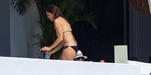 Cindy Crawford wore a skimpy black string bikini for her sun-soaked getaway in Mexico.