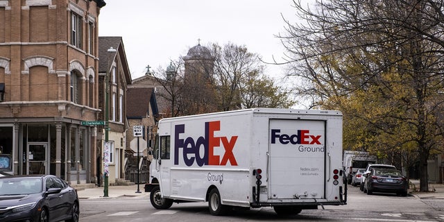 A FedEx Corp. Ground truck drives through the Bucktown neighborhood of Chicago, Illinois, in November 2020.