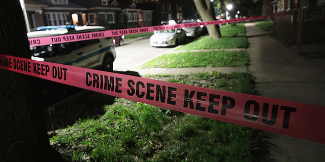 Crime scene tape is stretched around the front of a home where a man was shot on May 28, 2017, in Chicago, Illinois.