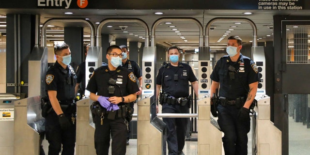 NEW YORK, NY - MAY 15: Police officers on patrol around Times Square subway station on May 15, 2020 in New York City.