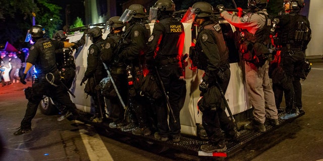 Portland police confront demonstrators in front of the Federal courthouse on September 26, 2020, in downtown Portland, Oregon. (Photo by Andrew Lichtenstein/Corbis via Getty Images)