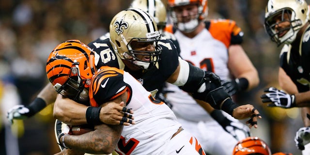 Glenn Foster (97) of the New Orleans Saints tackles Jeremy Hill (32) of the Cincinnati Bengals during the second half against the New Orleans Saints at Mercedes-Benz Superdome on Nov. 16, 2014, in New Orleans, Louisiana.  