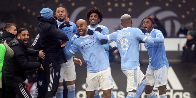 New York City FC players celebrate their penalty kick shootout win over the Portland Timbers in the MLS Cup soccer game, Saturday, Dec. 11, 2021, in Portland, Ore. (AP Photo/Amanda Loman)