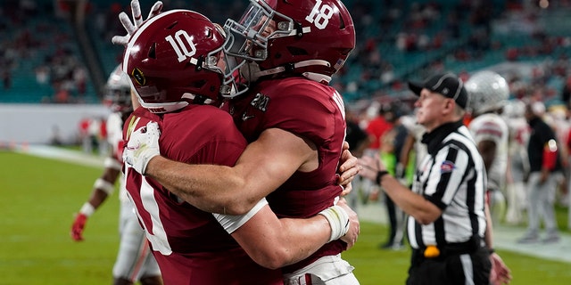 Alabama wide receiver Slade Bolden, right, celebrates after scoring a touchdown with quarterback Mac Jones during the second half of an NCAA College Football Playoff national championship game against Ohio State, Monday, Jan. 11, 2021, in Miami Gardens, Fla.