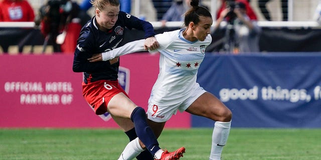 Chicago Red Stars forward Mallory Pugh (9) and Washington Spirit defender Emily Sonnett (6) fight for the ball during the first half of the NWSL Championship soccer match Saturday, Nov. 20, 2021, in Louisville, Ky.