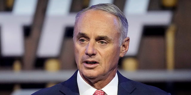 FILE - In this July 11, 2021, file photo, Major League Baseball Commissioner Rob Manfred kicks off the first round of the 2021 MLB baseball draft in Denver. Baseball’s ninth work stoppage and first in 26 years appears almost certain to start Dec. 2, 2021, freezing the free-agent market and threatening the start of spring training in February.
