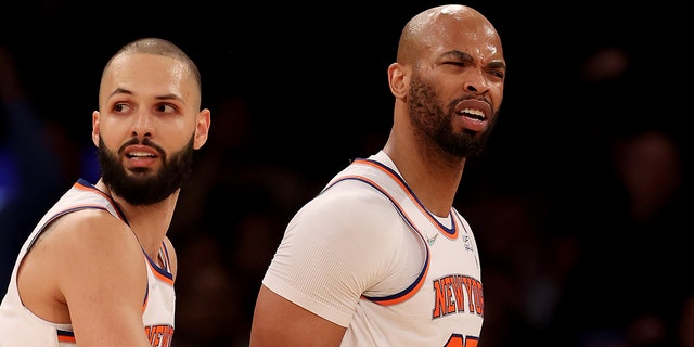 Taj Gibson (67) of the New York Knicks is held back by teammate Evan Fournier (13) after Gibson is called for double technical fouls and is ejected from the game in the first half against the Chicago Bulls at Madison Square Garden Dec. 2, 2021 in New York City.