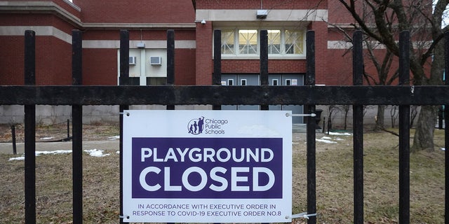 A sign outside of Columbus Elementary School lets visitors know that the playground has been closed on January 25, 2021 in Chicago, Ill. Chicago Public School teachers were scheduled to return to the classroom for in-person learning today, but the union objected and voted to continue remote learning.  (Photo by Scott Olson/Getty Images)
