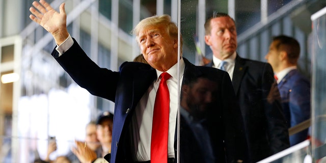 Former President Donald Trump waves prior to Game Four of the World Series iin Atlanta on Oct. 30, 2021.