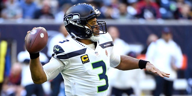 Seattle Seahawks quarterback Russell Wilson (3) throws against the Houston Texans during the first half of an NFL football game, Sunday, Dec. 12, 2021, in Houston.