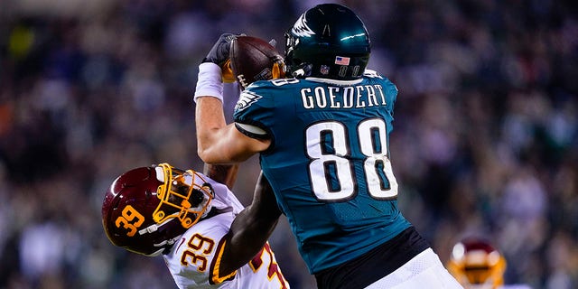 Philadelphia Eagles' Dallas Goedert, right, makes a catch while Washington Football Team's Jeremy Reaves defends during the first half of an NFL football game, Tuesday, Dec. 21, 2021, in Philadelphia.