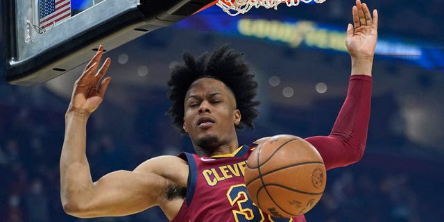 Cleveland Cavaliers' Isaac Okoro dunks against the Brooklyn Nets in the first half of an NBA basketball game, Monday, Jan. 17, 2022, in Cleveland.