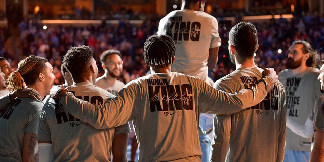 The Memphis Grizzlies stand on the court before an NBA basketball game against the Chicago Bulls on Martin Luther King Jr. Day, Monday, Jan. 17, 2022, in Memphis, Tenn.