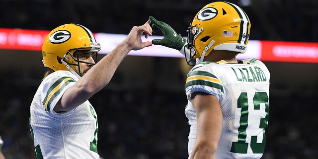 Green Bay Packers wide receiver Allen Lazard is congratulated by quarterback Aaron Rodgers after a 29-yard pass for a touchdown during the first half of an NFL football game against the Detroit Lions, Sunday, Jan. 9, 2022, in Detroit. 