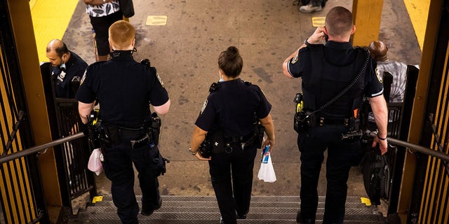 New York Police Department (NYPD) officers patrol in the Franklin Avenue subway station.