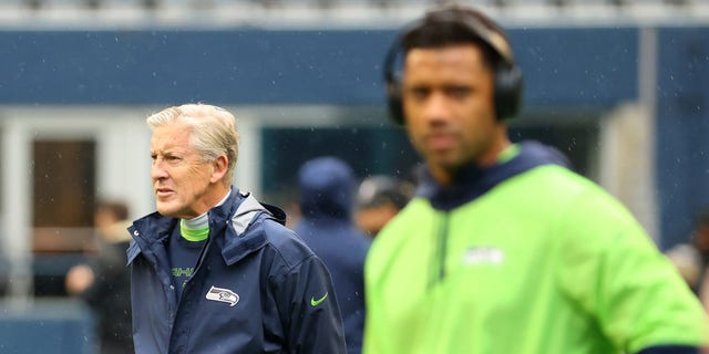 Head Coach Pete Carroll of the Seattle Seahawks looks on alongside Russell Wilson #3 before the game against the New Orleans Saints at Lumen Field on Oct. 25, 2021 in Seattle, Washington.