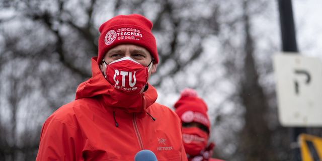 Chicago Teachers Union President Jesse Sharkey speaks ahead of a car caravan where teachers and supporters gathered to demand a safe and equitable return to in-person learning during the COVID-19 pandemic in Chicago, Illinois on Dec. 12, 2020. 