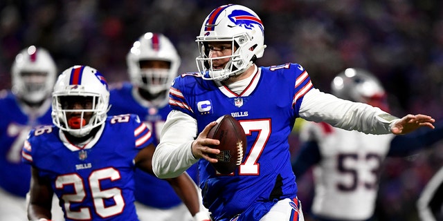 Buffalo Bills quarterback Josh Allen (17) runs the ball during the first half of an NFL wild-card playoff football game against the New England Patriots, Saturday, Jan. 15, 2022, in Orchard Park, N.Y.