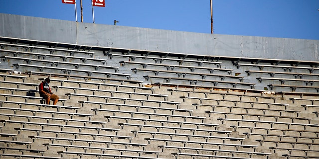 A lone fan sits in the stands waiting the kickoff between UAB and Central Arkansas before an NCAA college football game at Legion Field Sept. 3, 2020, in Birmingham, Alabama.