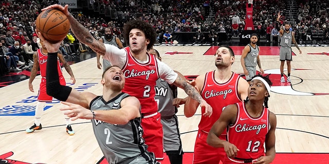 Chicago Bulls' Lonzo Ball (2) blocks the shot of Brooklyn Nets' Blake Griffin (2) during the second half of an NBA basketball game Wednesday, Jan. 12, 2022, in Chicago. The Nets won 138-112.