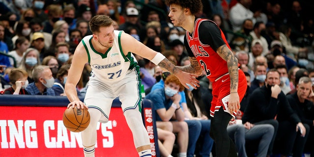 Dallas Mavericks guard Luka Doncic (77) is guarded by Chicago Bulls guard Lonzo Ball (2) in the first half of an NBA basketball game in Dallas, Sunday, Jan. 9, 2022.