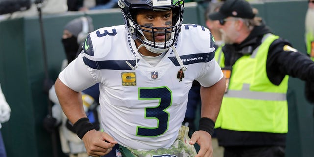 Seattle Seahawks' Russell Wilson takes the field before an NFL football game against the Green Bay Packers Sunday, Nov. 14, 2021, in Green Bay, Wis.