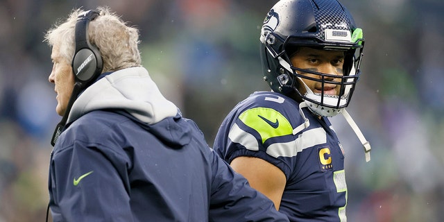 Head coach Pete Carroll and Russell Wilson of the Seattle Seahawks interact on the sidelines during the second half against the Detroit Lions at Lumen Field on Jan. 2, 2022, in Seattle, Washington.