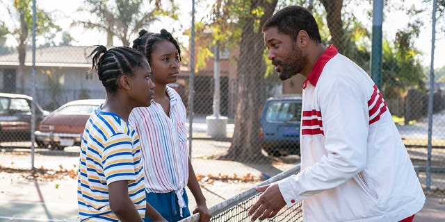 Will Smith, right, with Demi Singleton, left, and Saniyya Sidney in a scene from "King Richard." 