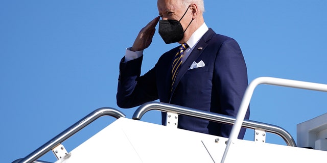 President Biden salutes as he boards Air Force One, Tuesday, Jan. 11, 2022, at Andrews Air Force Base, Maryland. Biden was en route to Atlanta. 