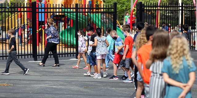 Teacher Nusheen Saadat, second from left, leads students across campus during a summer school session at Golden View Elementary School on Monday, June 14, 2021, in San Ramon, Calif.  (Photo by Aric Crabb/MediaNews Group/East Bay Times via Getty Images)