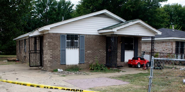 The outside of a Memphis home where a fire killed 10 people. Metal bars were placed over most windows of the house. (Associated Press)