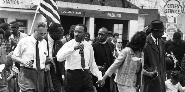 March 1965:  Martin Luther King (1929  - 1968) and his wife Coretta Scott King lead a civil rights march from Selma, Alabama, to the state capital in Montgomery. (Photo by William Lovelace/Express/Getty Images)