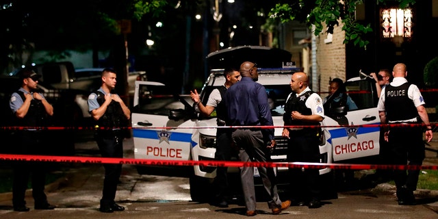 Chicago police officers investigate the scene of a shooting in Chicago, Illinois, on July 21, 2020. (KAMIL KRZACZYNSKI/AFP via Getty Images)