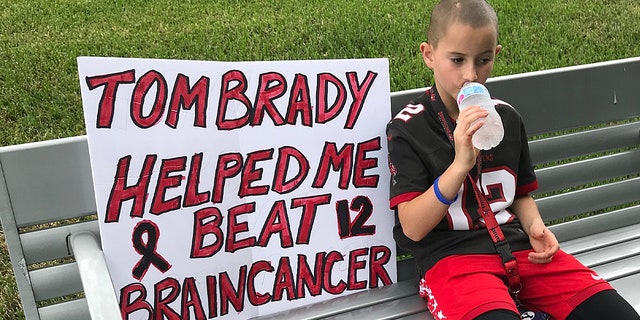 Noah Reeb held the sign at a Bucs game and caught the attention of Tom Brady.