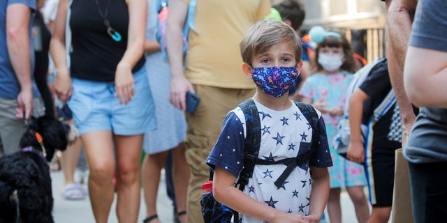 A child wears a face mask on the first day of New York City schools amid the COVID-19 pandemic in Brooklyn, New York, Sept. 13, 2021. 