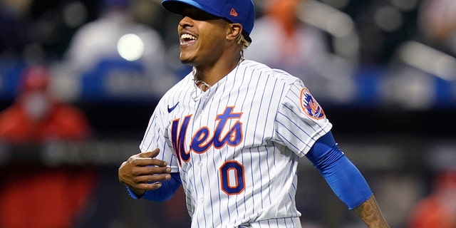 New York Mets starting pitcher Marcus Stroman celebrates after the Philadelphia Phillies' Rhys Hoskins grounded into a double play during the sixth inning of the second game of a doubleheader April 13, 2021, in New York.