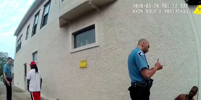 FILE - In this image from police body camera video shown as evidence in court, Minneapolis police Officers Thomas Lane, left, and J. Alexander Kueng, second from right, gather information as they take George Floyd into custody outside Cup Foods in Minneapolis, on May 25, 2020. 