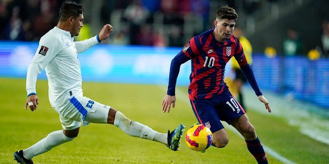 El Salvador's Roberto Dominguez, left, and United States' Christian Pulisic compete for possession during the first half of a FIFA World Cup qualifying soccer match, Thursday, Jan. 27, 2022, in Columbus, Ohio. The U.S. won 1-0.