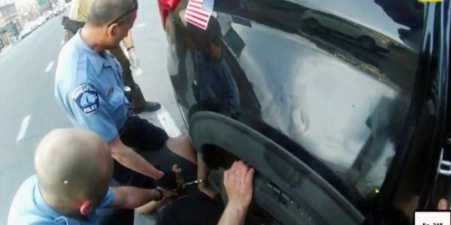 In this image from police body camera video shown as evidence in court, paramedics arrive as Minneapolis police officers, including Derick Chauvin, second from left, and J. Alexander Kueng restrain George Floyd in Minneapolis, on May 25, 2020. 