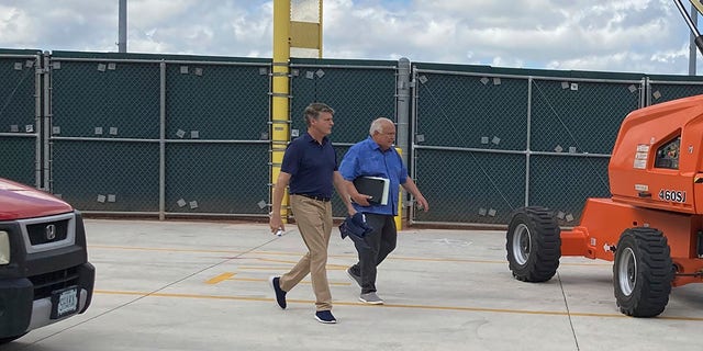 New York Yankees managing general partner Hal Steinbrenner, left, and San Diego Padres vice chairman Ron Fowler walk at Roger Dean Stadium in Jupiter, Fla., where baseball labor talks continue Thursday, Feb. 24, 2022.