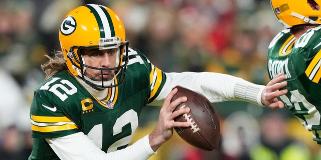 Quarterback Aaron Rodgers of the Green Bay Packers scrambles during the 1st quarter of an NFC divisional playoff game against the San Francisco 49ers at Lambeau Field Jan. 22, 2022, in Green Bay, Wis.