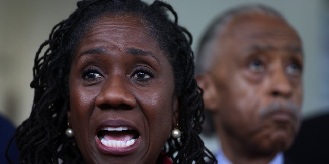 Civil rights leader Sherrilyn Ifill of the NAACP Legal Defense Fund speaks as the Rev. Al Sharpton of the National Action Network looks on at a news briefing outside the West Wing of the White House following a meeting with President Joe Biden and Vice President Kamala Harris July 8, 2021, in Washington, D.C. 