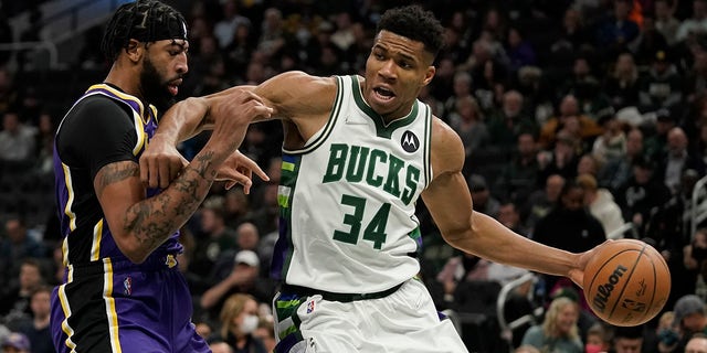 The Milwaukee Bucks' Giannis Antetokounmpo tries to get past the Los Angeles Lakers' Anthony Davis during the second half of a game Wednesday, Nov. 17, 2021, in Milwaukee. 