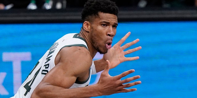 Milwaukee Bucks forward Giannis Antetokounmpo reacts after dunking during the first half of Game 5 of a second-round playoff series June 15, 2021, in New York.