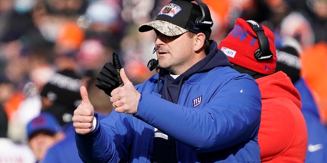 New York Giants head coach Joe Judge signals his team during the first half of an NFL football game against the Chicago Bears Sunday, Jan. 2, 2022, in Chicago.