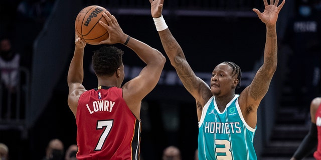 Charlotte Hornets guard Terry Rozier (3) defends against Miami Heat guard Kyle Lowry (7) during the first half of an NBA basketball game Thursday, Feb. 17, 2022, in Charlotte, N.C.